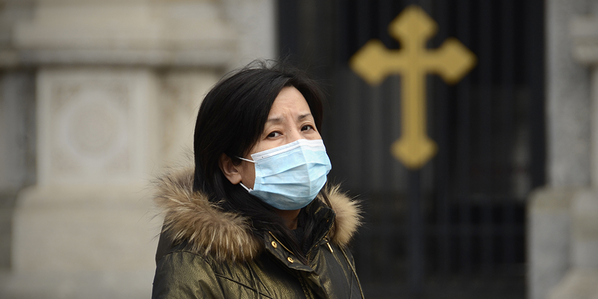 web3-woman-face-mask-sick-protect-church-cross-afp-000_hkg8174497